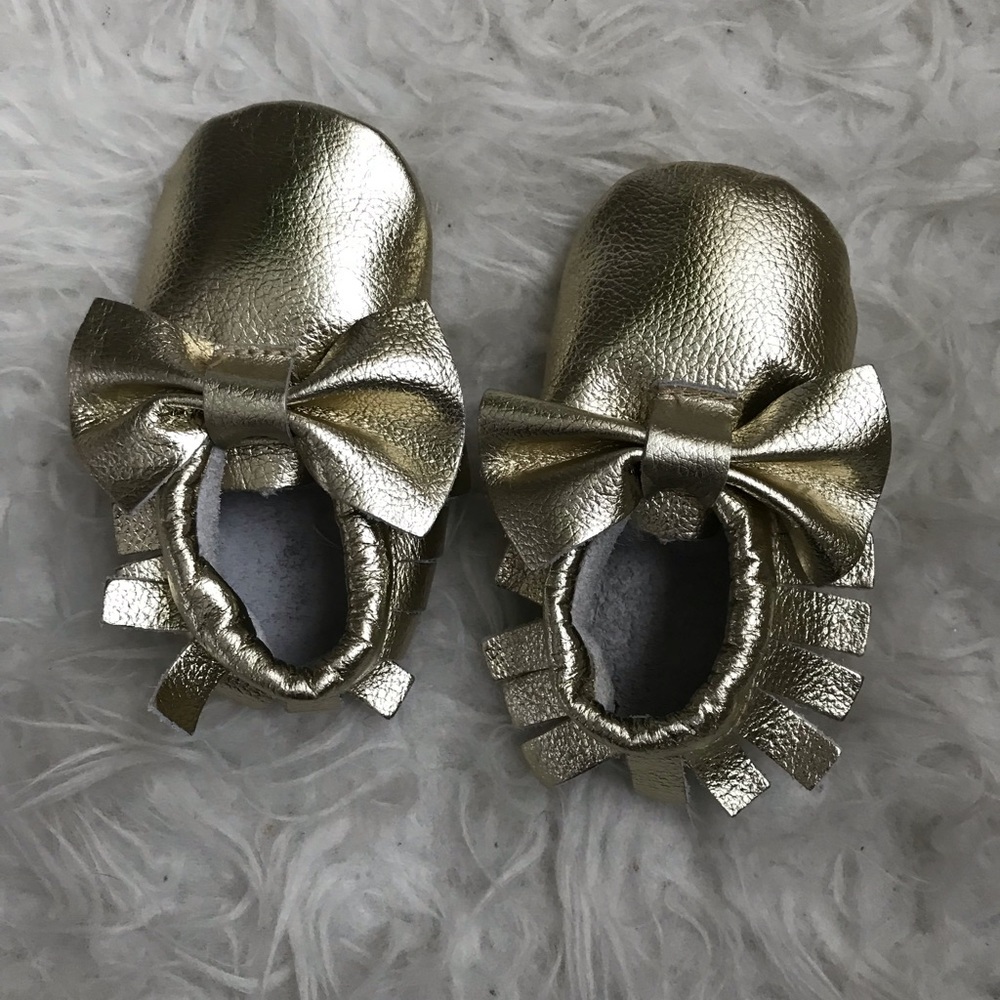 Never worn gold moccasins with bows